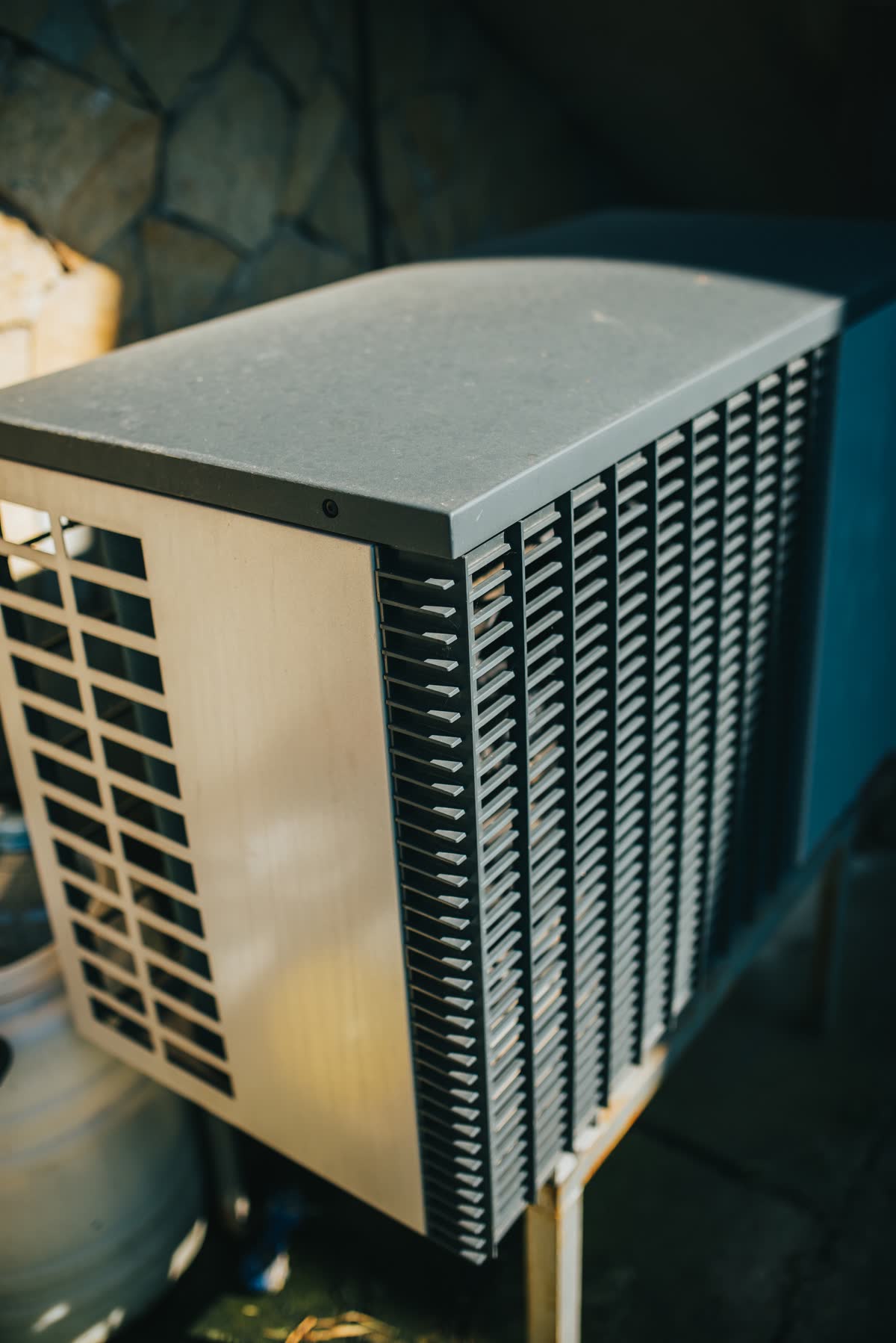 Outdoor air conditioning unit installed beside a house with a tidy refrigerant line run