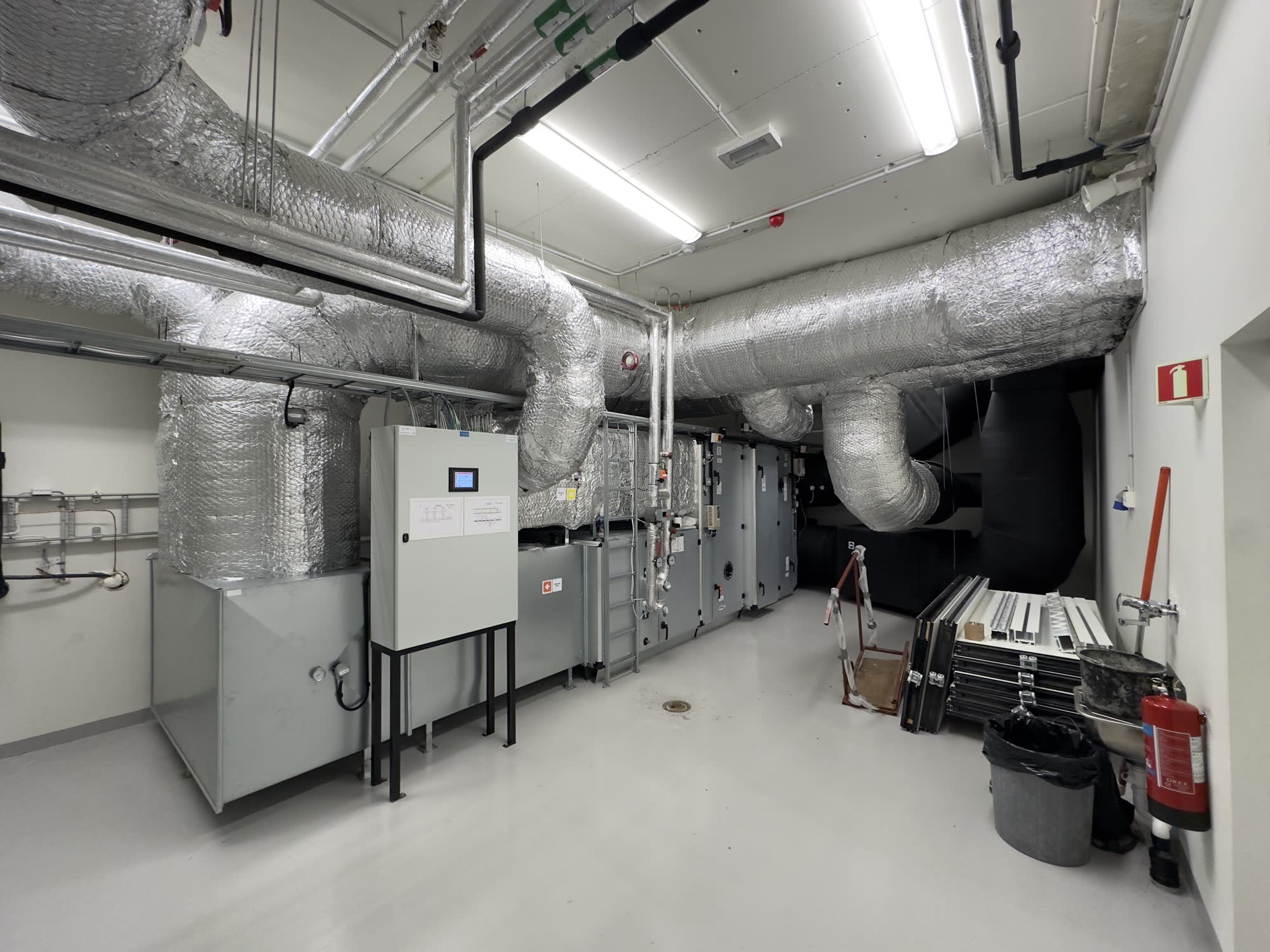 Mechanical room with a ventilation unit and insulated duct runs