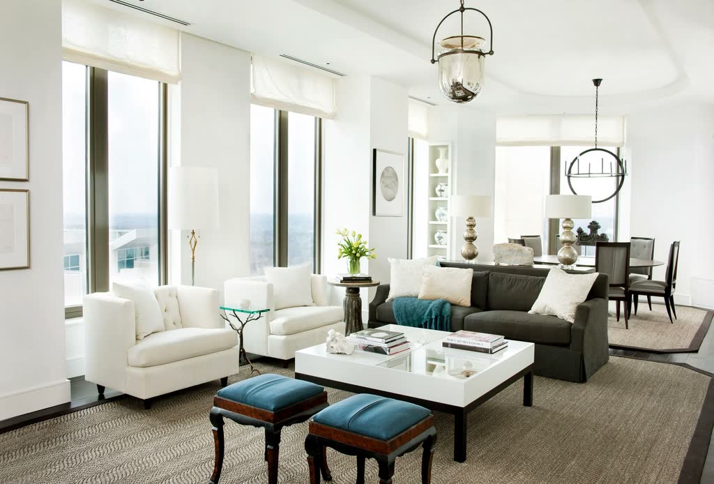 Bright, cool modern living room with a white sofa and large windows